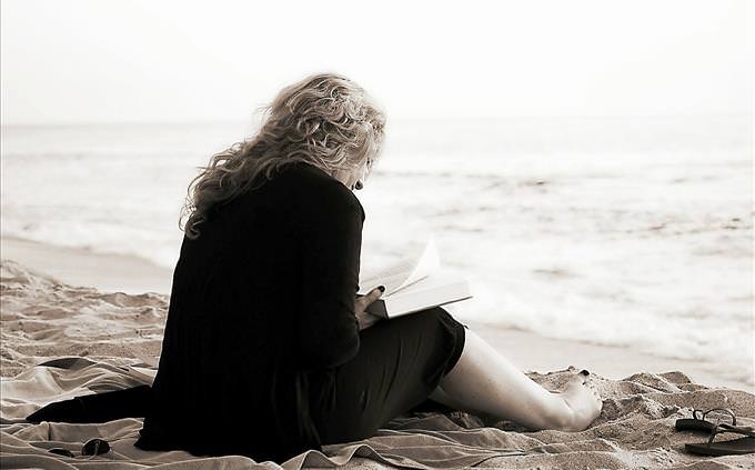 woman reading on the beach
