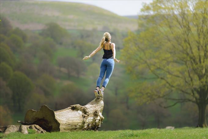 woman stretching on log
