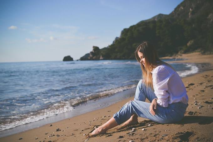 A woman sitting on a beach