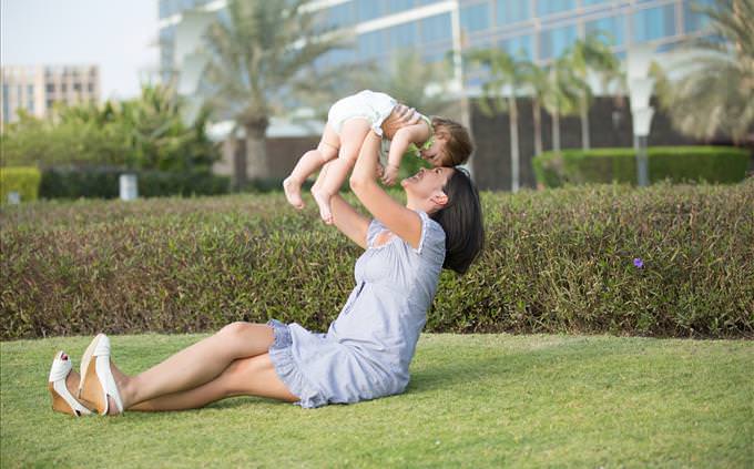 mother holding baby outdoors