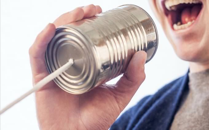 man talking through a tin can