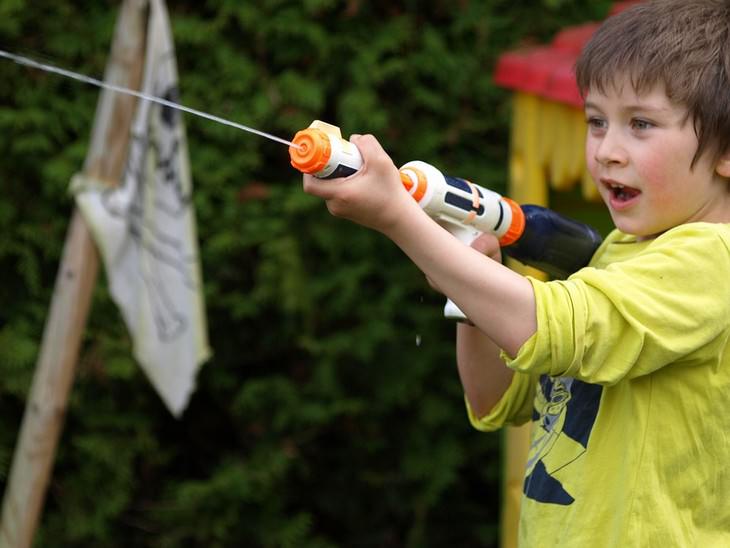 boy shooting water gun