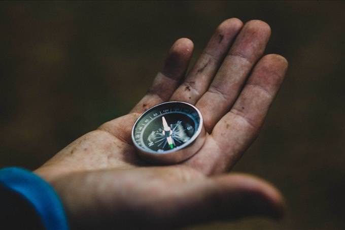 hand holding a compass