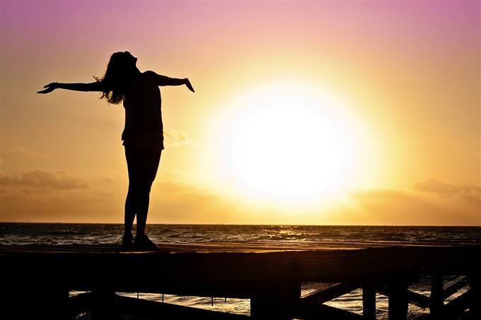 Silhouette of a woman with her arms to the sides