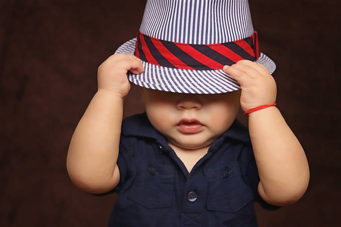 A baby with a hat on his head