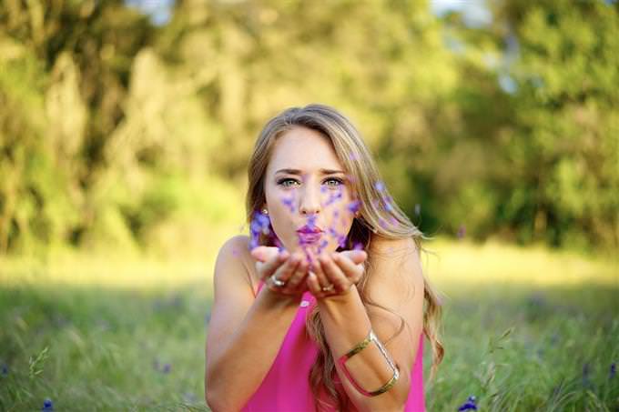 A woman breathes on her flowers