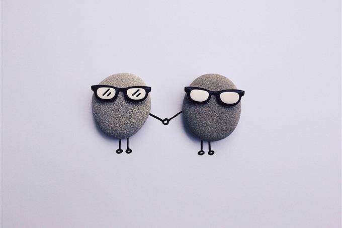 Two pebbles with sunglasses