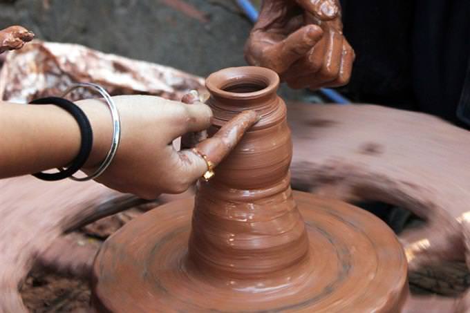 Hands sculpting clay