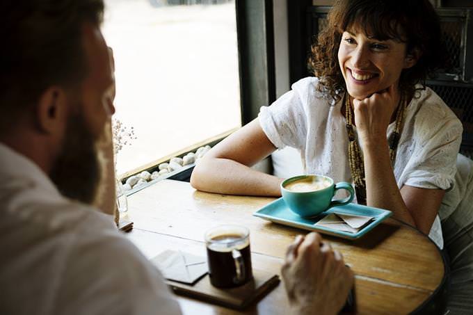A woman having a conversation with a man and smiling