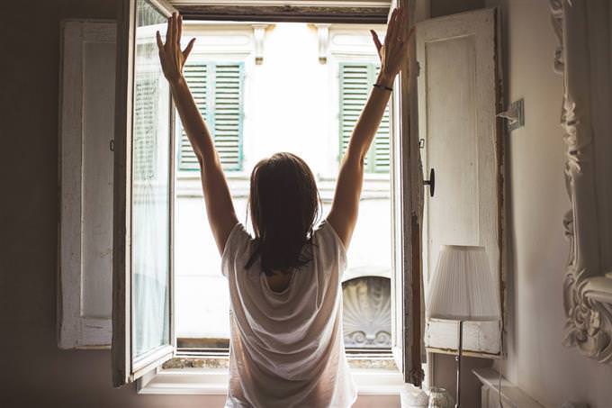 A woman stretching out in front of a window