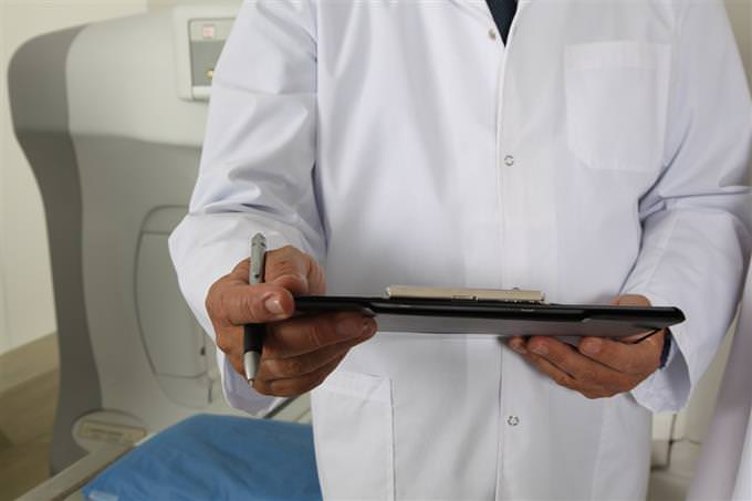 A doctor holding a medical sheet