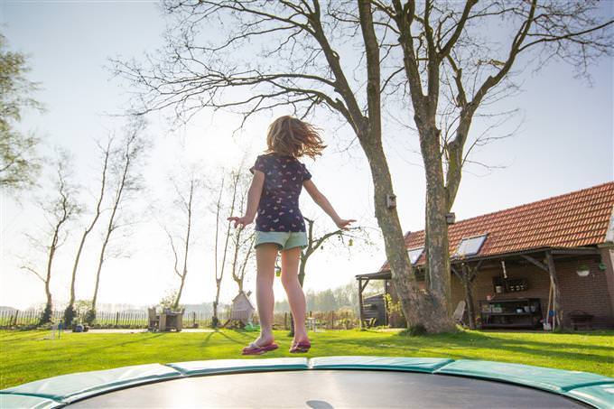 A boy jumping on a trampoline