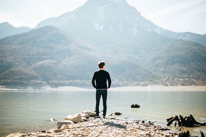 A man standing in front of a lake