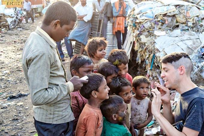 A man helping children from a third world country
