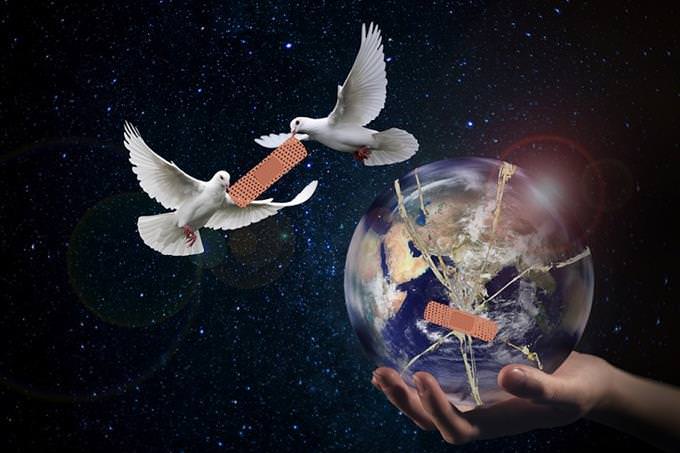 A hand holding the earth with a bandage on it next to two doves holding another bandage