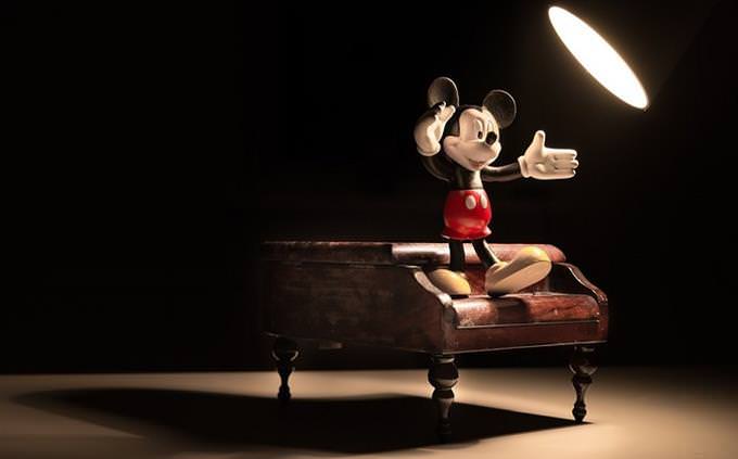 A Mickey Mouse doll on a piano