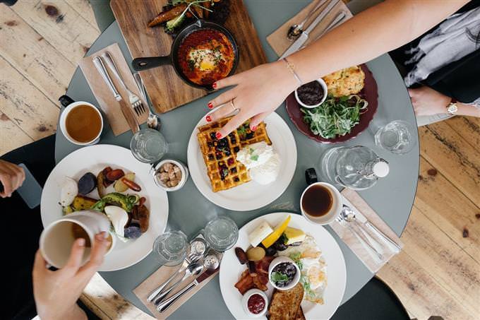 Hands around a table in a restaurant