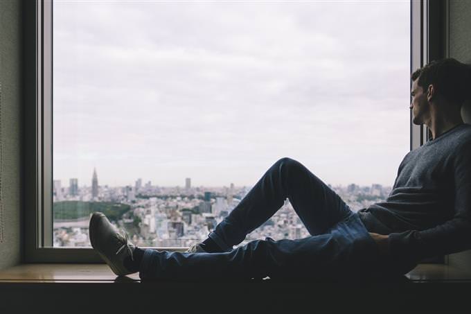 A man sitting on a windowsill