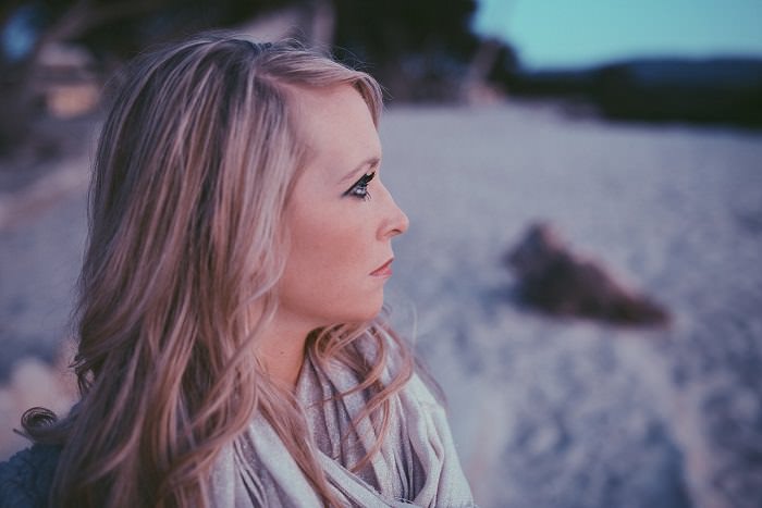 woman staring pensively on the beach 
