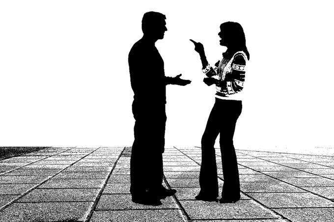 The silhouettes of a couple arguing