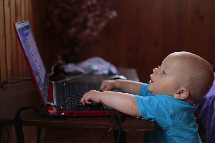 baby reaching for a laptop 