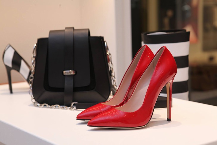 red womens patent leather stilletos and a black womens bag