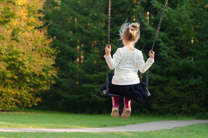 little girl on a swing