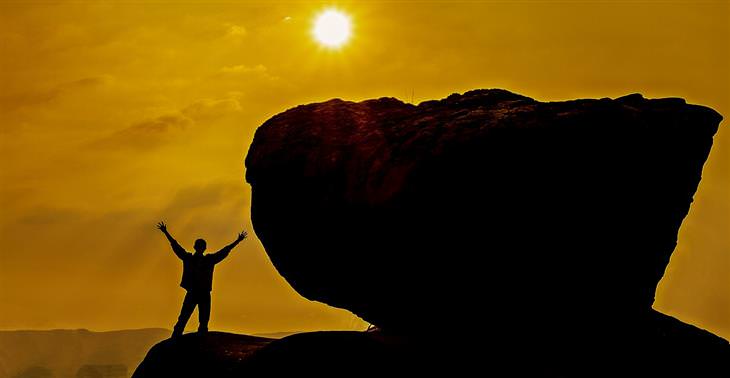 habits: silhouette of a man next to a boulder