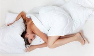 a woman sleeping  in a Fetal position