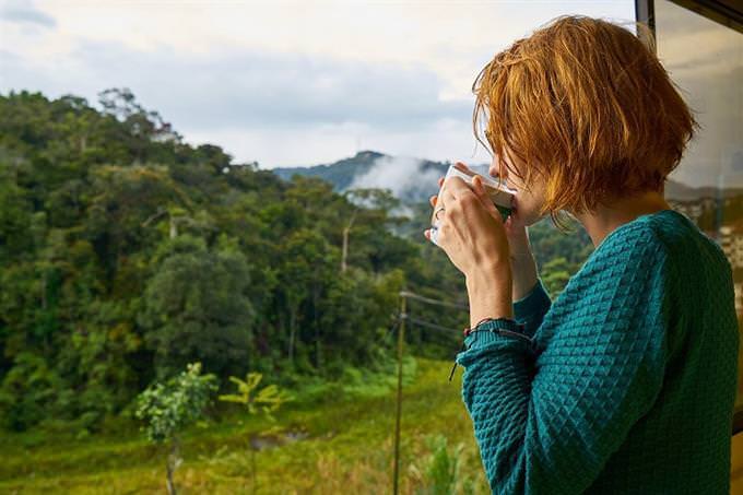 A woman drinking a cup of hot coffee