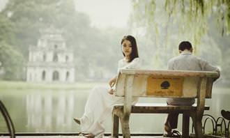 Find the differences: couple sitting on a bench in front of a lake