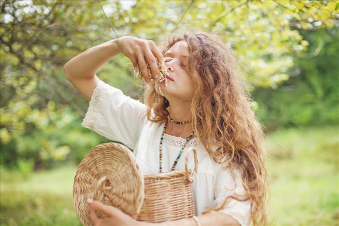 young girl smelling herbs