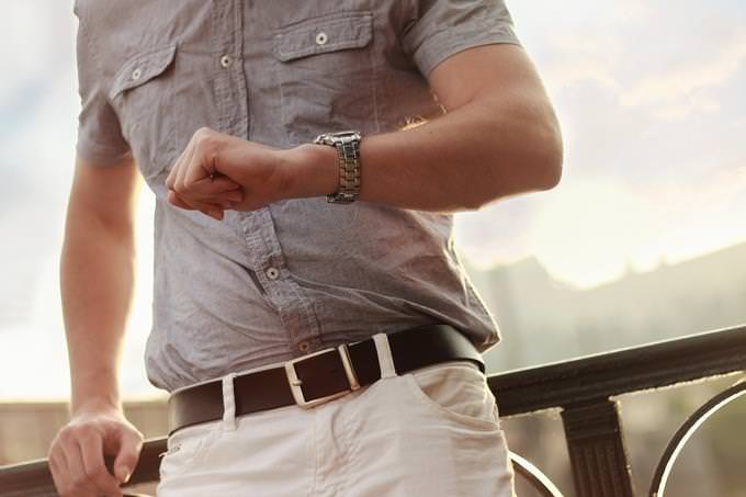 Personality test: A man looking at his wristwatch