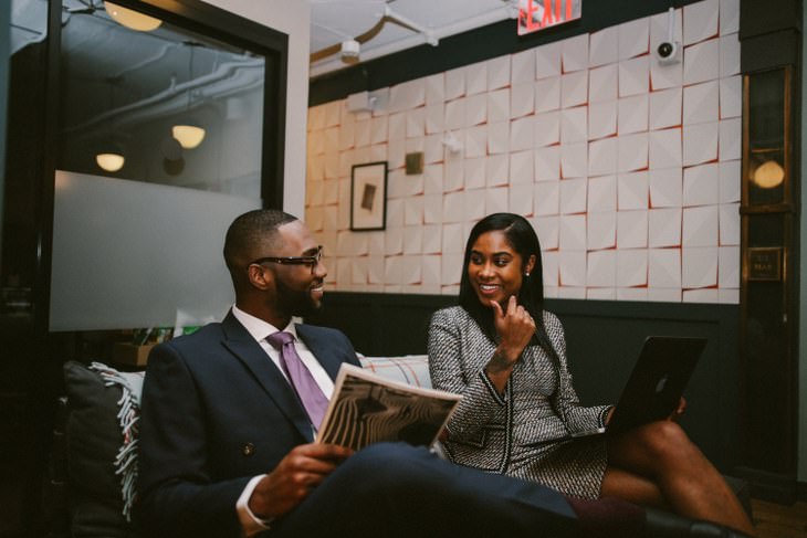 Two professionals laughing at funny puns