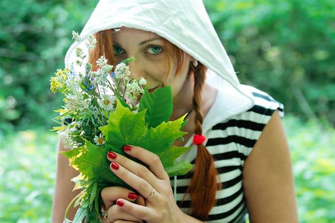 woman smelling bouqet of flowers