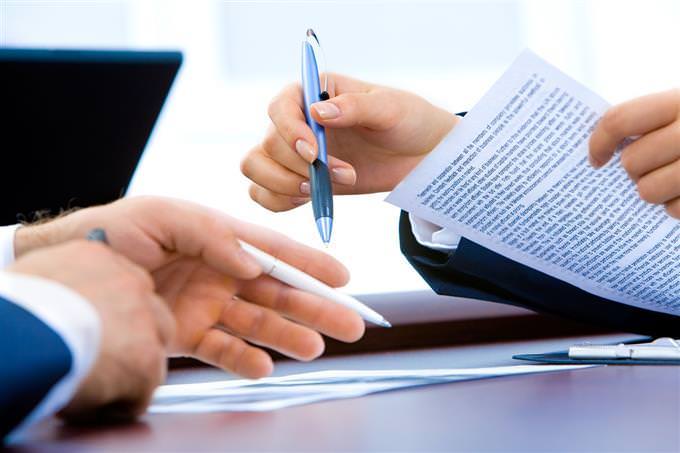 People's hands with pens and papers