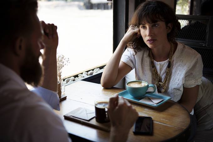 A woman and a man sitting in a cafe