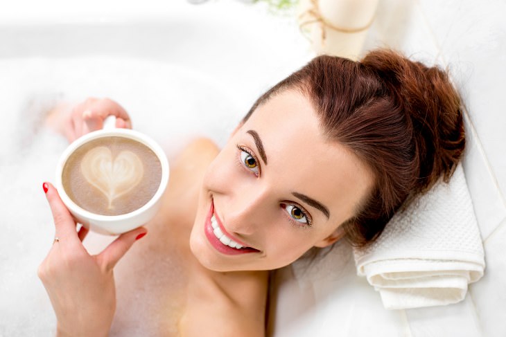 woman drinking coffee in bath