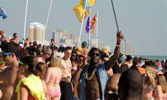 Young people dancing at a beach party