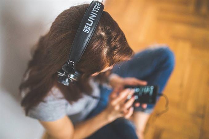 A woman with headphones on listening to music