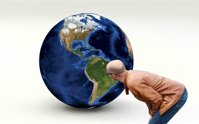 A man looking at a globe