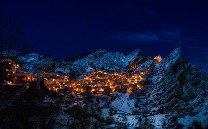 A village in a mountainous area at night