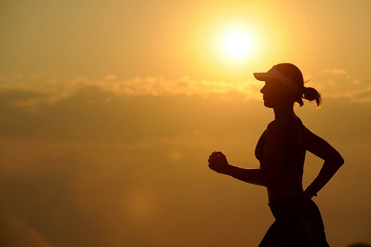 woman running with the sunset in the background