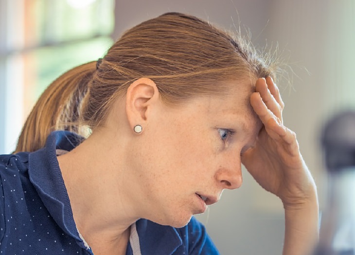 woman with head in hands