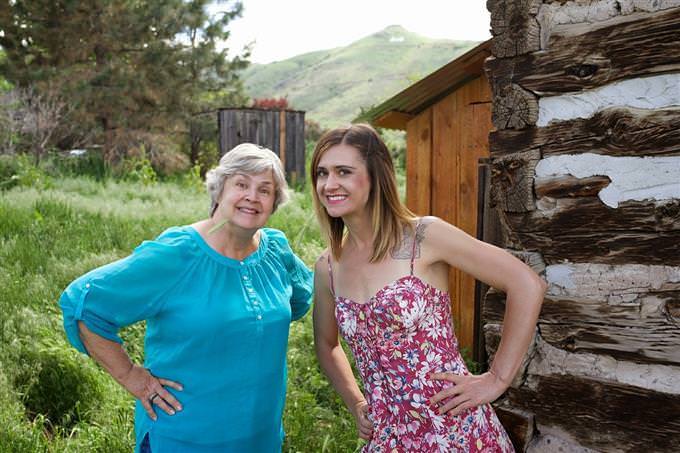 A woman next to her mother smiling at the camera