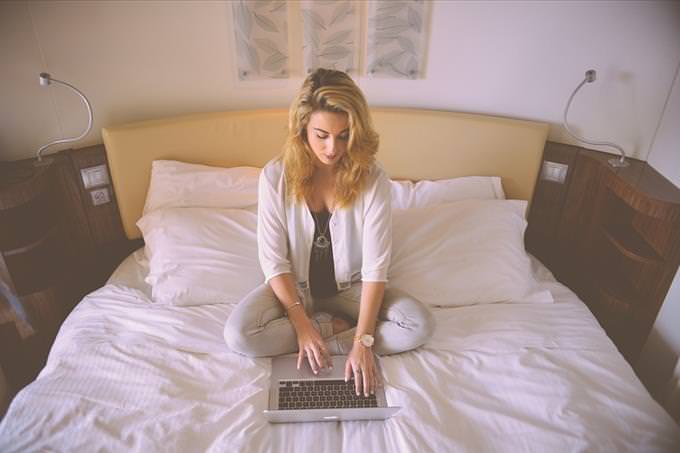 woman working on bed