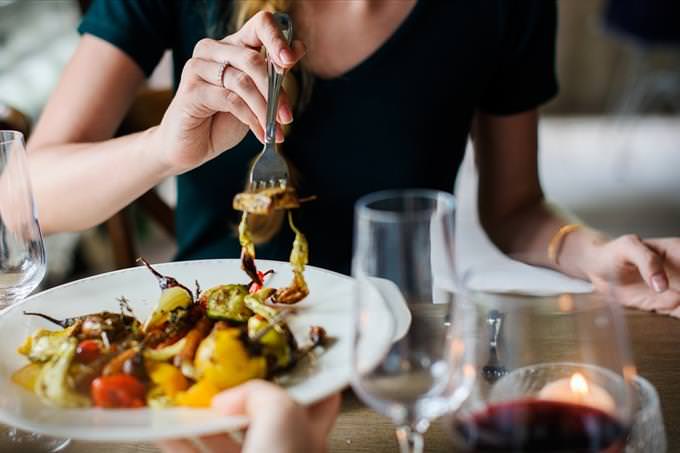 woman eating roast vegetables