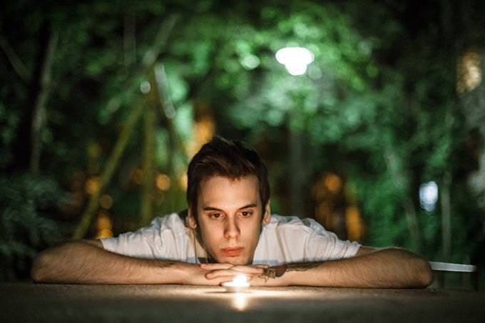 A man looking at a candle