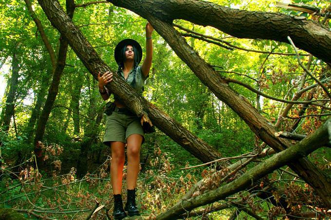 A woman among tree trunks