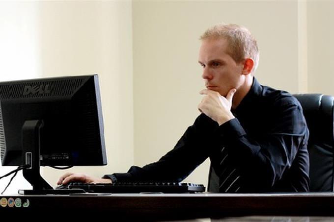 A businessman sitting in front of a computer